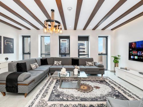 a living room with a couch and a table at Luxury 3 Bedroom Sub Penthouse in Dubai