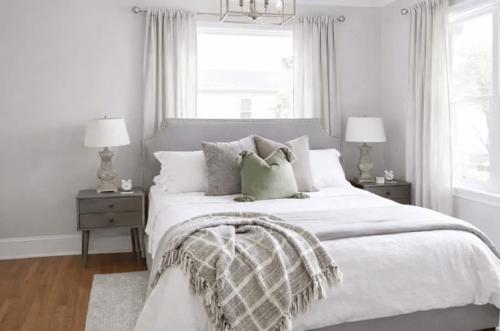 a white bedroom with a large white bed with pillows at Vida Boutique Inn in Worcester