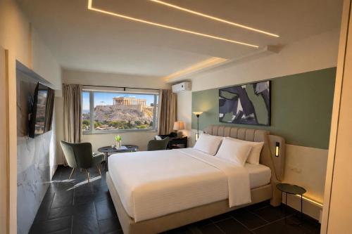 a hotel room with a bed and a window at Elite Ermou Suites in Athens