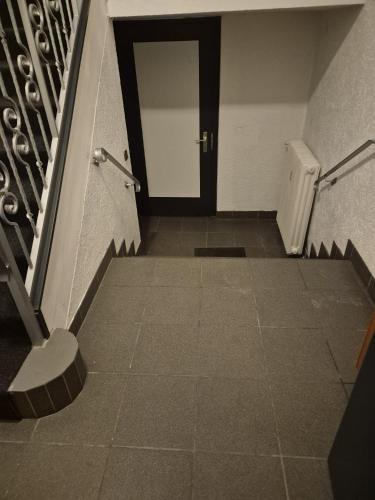 a hallway with a door and a tile floor at Waterloo Sunset Hotel in Erzhausen