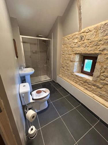 a bathroom with a toilet and a sink at Poitevins in Saint-Astier