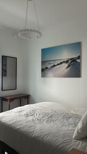 a bedroom with a bed and a picture on the wall at Köpingebro in Köpingebro
