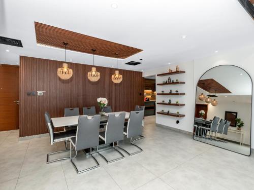 a dining room with a table and chairs at Luxury 3 Bedroom Sub Penthouse in Dubai