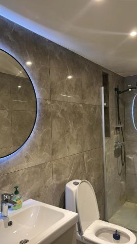 a bathroom with a sink and a toilet and a shower at Köpingebro in Köpingebro