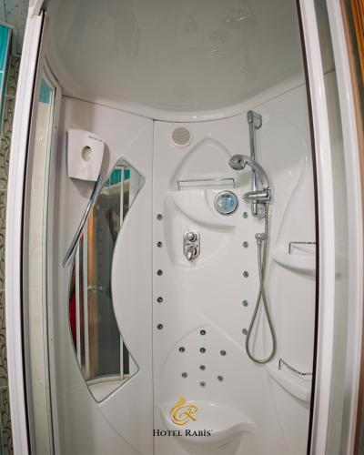 a bathroom with a shower and a toilet at Hotel RABİS in Urfa