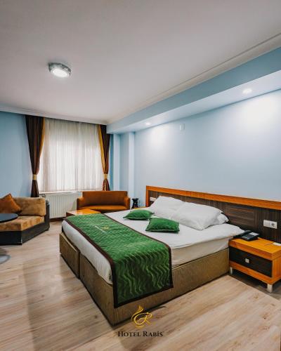 a bedroom with a large bed and a couch at Hotel RABİS in Urfa