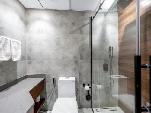 a bathroom with a toilet and a glass shower at Luxury 3 Bedroom Sub Penthouse in Dubai