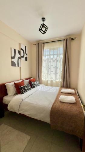 a bedroom with a large bed with pillows on it at My Humble Abode - Machakos in Machakos