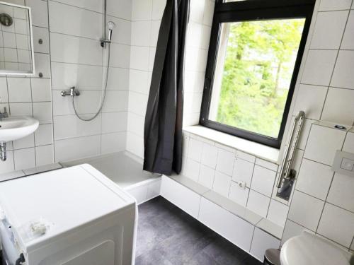 a bathroom with a sink and a toilet and a window at ST10-12 Monteurwohnung in Stolberg in Binsfeldhammer