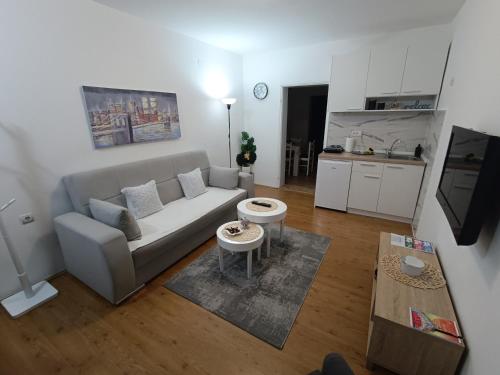 a living room with a couch and a table at Apartman LISA in Niš