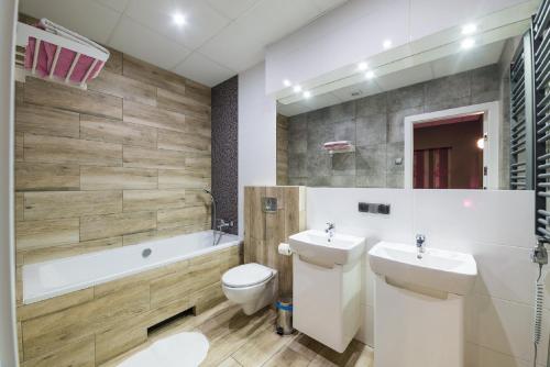 a bathroom with a sink and a toilet and a tub at Hostel Filip 2 in Gdańsk