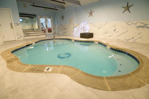 a large swimming pool in the middle of a building at Inn of The Dove Romantic Luxury & Business Suites in Bensalem