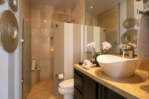 a bathroom with a sink and a toilet at Suites at Zona Romantica in Puerto Vallarta