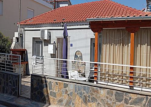a dog sitting on a balcony of a house at Elias Home in Volos