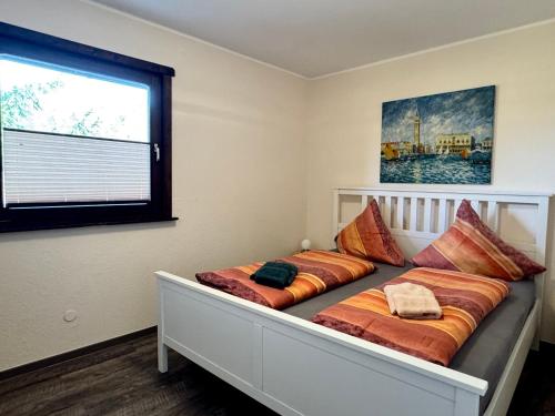 a bed in a room with two pillows on it at Räuberlager 15 in Dammbach