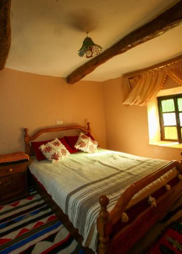 a bedroom with a bed and a window at Adrar view lodge in Imlil