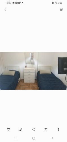 a room with two beds and a tv at Pacor in Mar del Plata