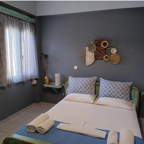 a bedroom with a large bed with towels on it at Mulberry house in Elafonisos
