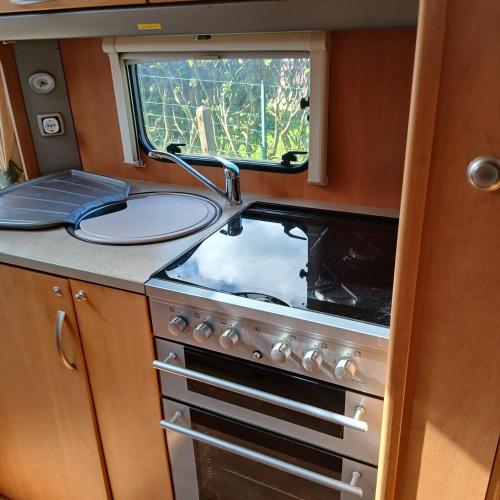 a kitchen with a stove and a sink at CaraCaux in Le Torp-Mesnil