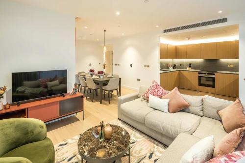 a living room with a couch and a dining room at Modern 3-Bedroom Apartment near Kings Cross & Coal Drops in London