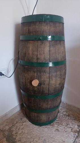 a wooden barrel with green bands on it at Casetta Wetto' in Monopoli