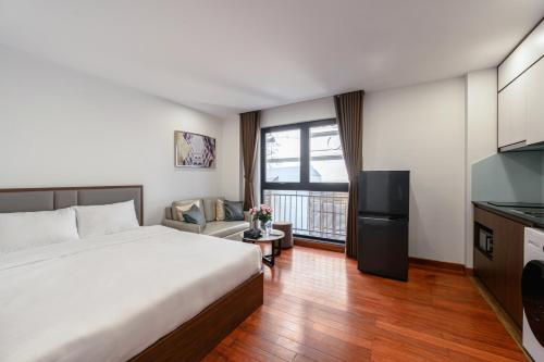 a hotel room with a bed and a kitchen at Luxe Paradise Suites - No34 Alley 260 Đội Cấn in Hanoi