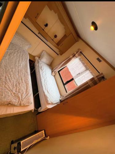 a small room with a window and a bed at Stenshemmet Holidayhome in Hjo