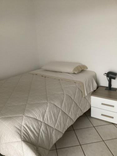 a bedroom with a bed and a night stand at Bed and Breakfast da Giuseppe, Camere vicino stabilimento Ferrari in Fiorano Modenese