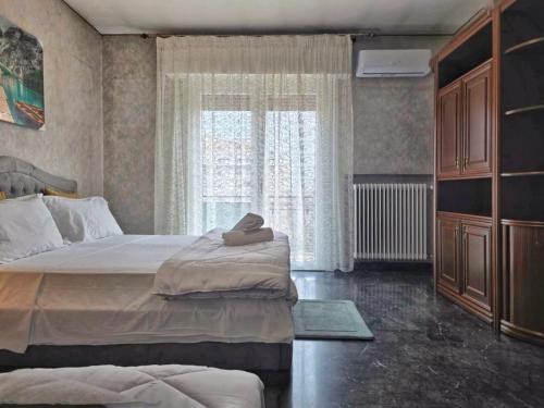 a bedroom with a large bed and a window at Altobello Venice Apartment in Mestre