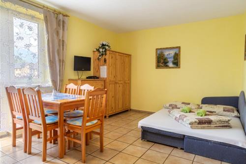 a room with a table and a bed and a dining room at Vila Horal in Liptovský Mikuláš