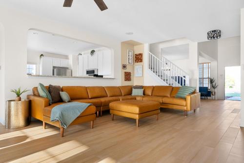 a living room with an orange couch and chairs at Large Groups' Luxury House - Pool - Sleep 22 in Round Rock