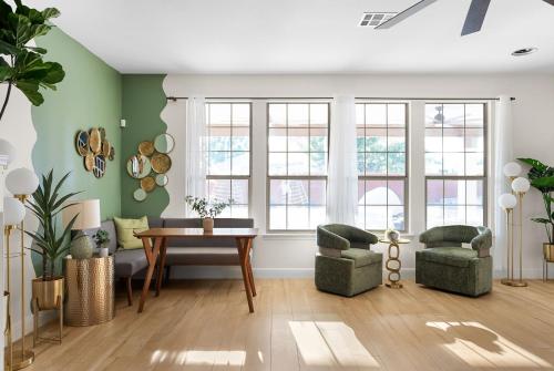 a living room with green walls and a table and chairs at Large Groups' Luxury House - Pool - Sleep 22 in Round Rock