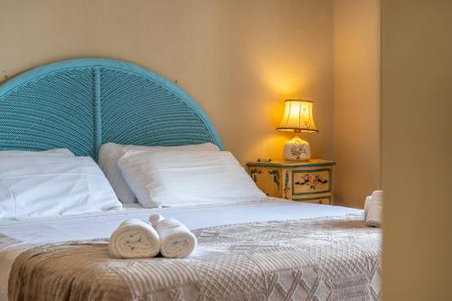 a bedroom with a bed with two towels on it at Villa Chichizola in Rapallo