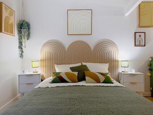 a bedroom with a large bed with two night stands at La Courette des Rois - Hyper centre & Chateau in Dourdan