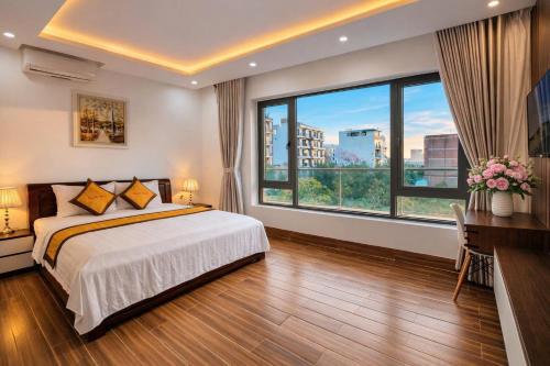 a bedroom with a bed and a large window at Villa FLC Sầm Sơn Đức Anh in Sầm Sơn