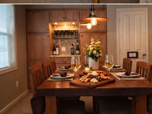 a dining room table with wine glasses and food on it at Picturesque Condo perfect for Golf, Families, Pools and Lake vacation in Bellaire