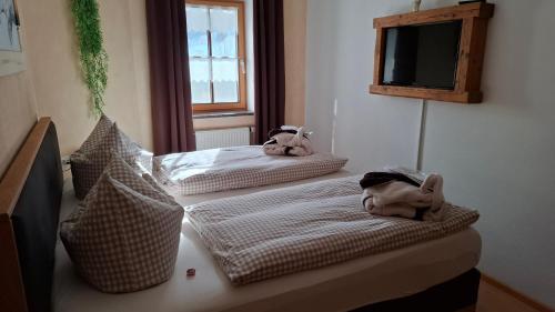 two beds in a room with towels on them at Ferienwohnung Oswald in Unterammergau
