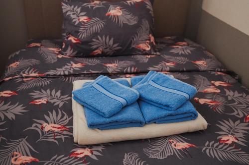 two blue towels sitting on top of a bed at LUX Apartman Jugi PARKING public free in Novi Pazar