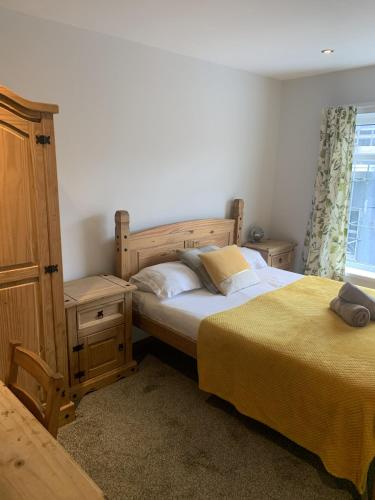 a bedroom with two beds next to a window at Camelot Seafront Hotel in Blackpool