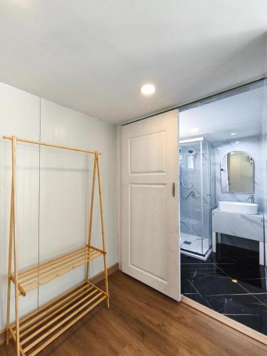 a room with a glass door and a bedroom at Secret Terrace Pool Villa Rayong in Ban Bua Phut