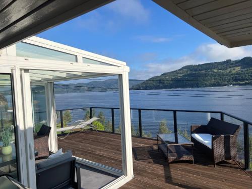 a balcony with a view of the water at Large house with panoramic sea view in Bergen