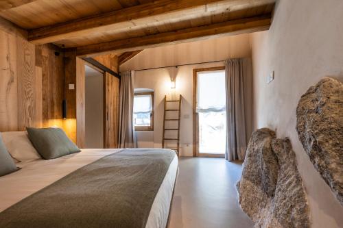 a bedroom with a bed and a window and a ladder at Al Crotto in Chiavenna