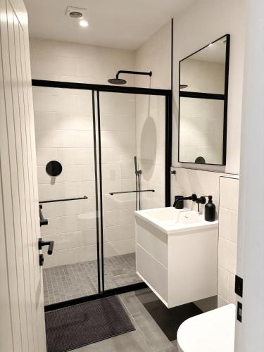 a white bathroom with a sink and a shower at Worlaby Coach House in Worlaby