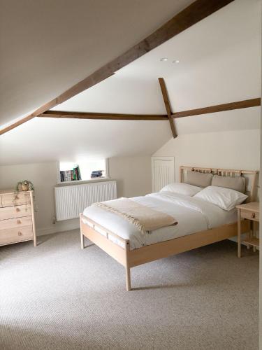 a bedroom with a large bed in a attic at Worlaby Coach House in Worlaby