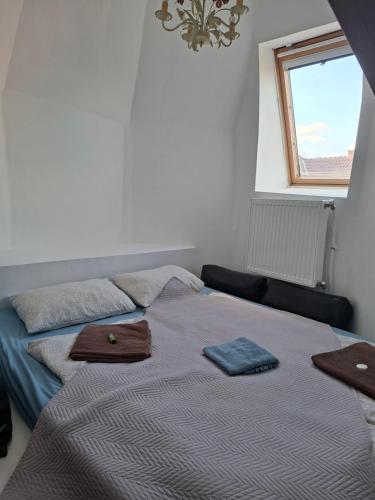 a bedroom with a bed with two plates on it at Siófok 7 Apartmanház in Siófok