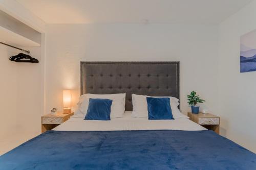 a bedroom with a large bed with blue pillows at CASA EN EL CENTRO & CORAZON DE CANCUN in Cancún