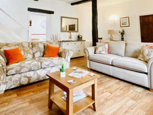 a living room with two couches and a coffee table at Brook House 2 - Uk31043 in Bassenthwaite