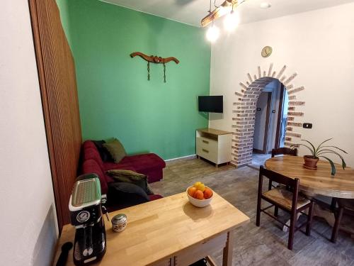 a living room with a table and a dining room at Podere Al Covo - House, Garden & Vineyard - Alghero in Alghero