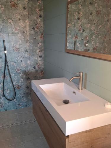 a bathroom with a sink and a shower at Casa Al Vento in Lucignano