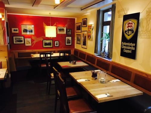 a restaurant with a bar and a large window at Brauereigasthof Krone Öhringen in Öhringen